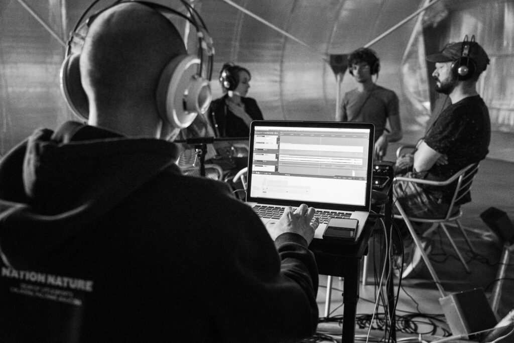 Audience experiencing a Hybrid Audio Diffusion System performance at IZIS Festival, 2023